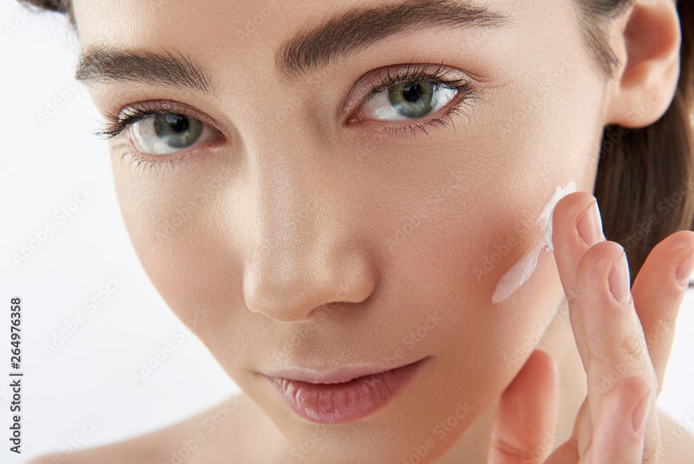 Close up sensual woman with cream on cheek Close up sensual woman with cream on cheek