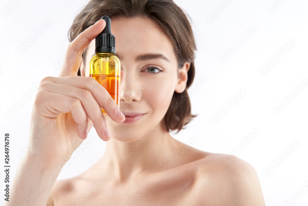 Fototapeta premium Close up little bottle with cosmetic oil