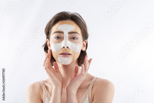Young brunette sensual woman with face mask
