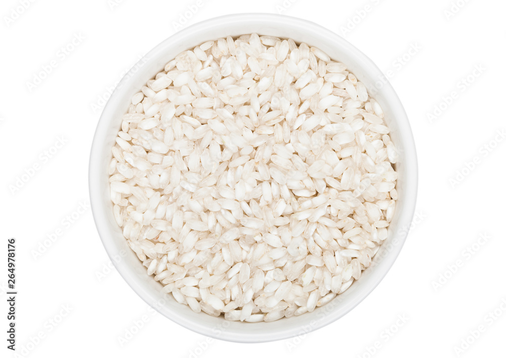 White bowl of raw organic arborio risotto rice on white background. Healthy food. White bowl of raw organic arborio risotto rice on white background. Healthy food.