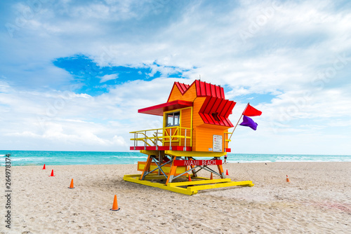 Colorful lifeguard tower in Miami Beach under a cloudy sky