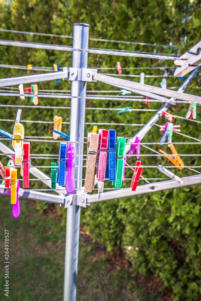 Clothes pegs on a dryer in a garden