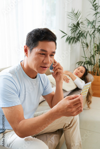 Man calling doctor for poisoned wife photo