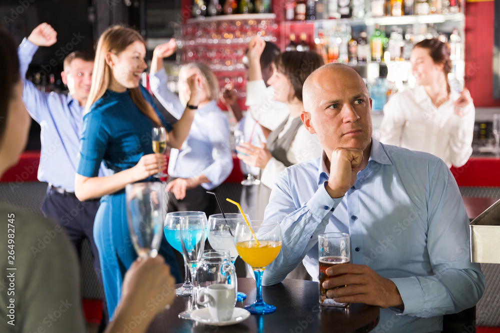 Worried businessman at corporate party