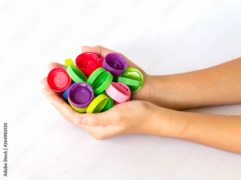 hand holding plastic bottles cap for recycling To help save the world concept hand holding plastic bottles cap for recycling To help save the world concept