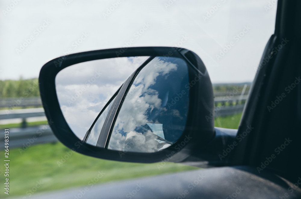 Landscape in the sideview mirror of a car