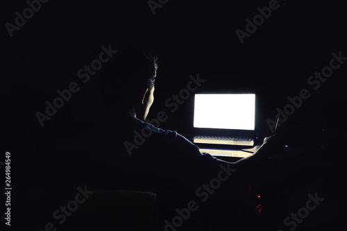 man working late at night. He looks worried, he sees on the computer screen in front of him,Computer vision syndrome