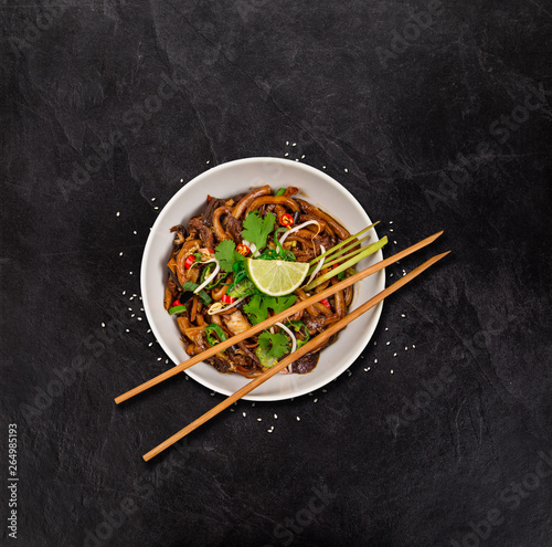Udon noodles asian food background on rustic stone table.