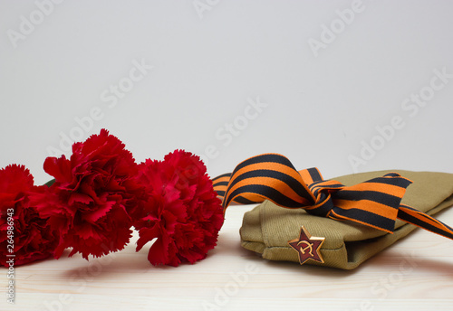 Victory day composition with clove, flight cap and saint George ribbon with free space