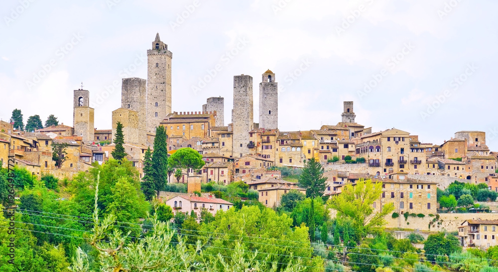 View of the historic cityscape of San Gimignano facing the countryside in Tuscany, Italy.