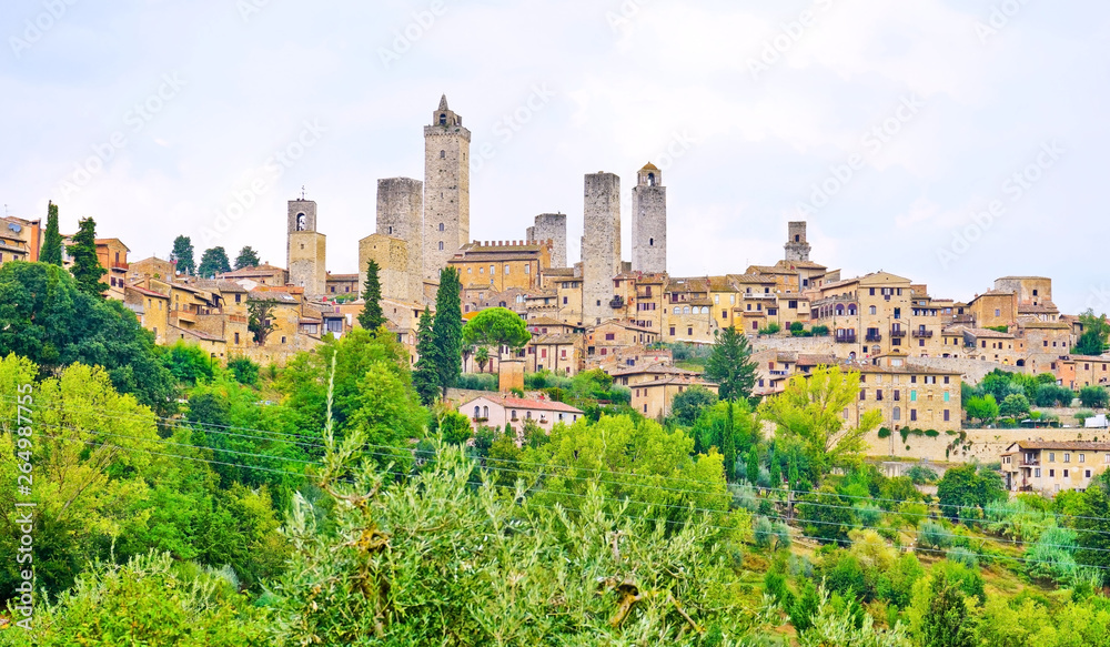 View of the historic cityscape of San Gimignano facing the countryside in Tuscany, Italy.