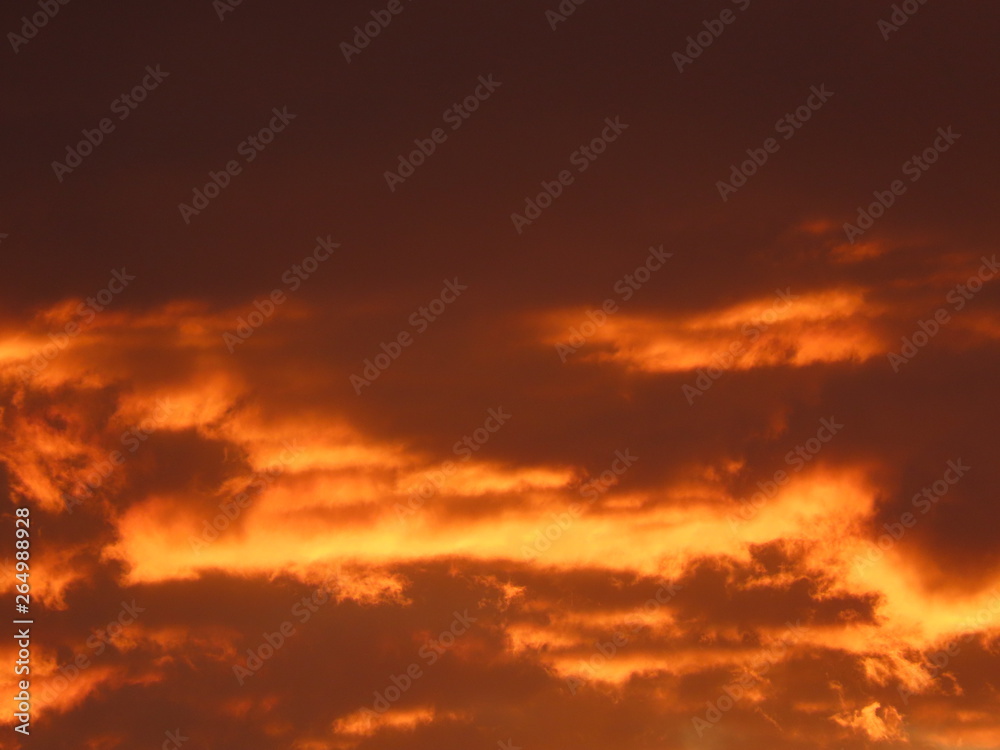 Dramatic dark clouds in sunset. Background with black, red, orange, yellow colors
