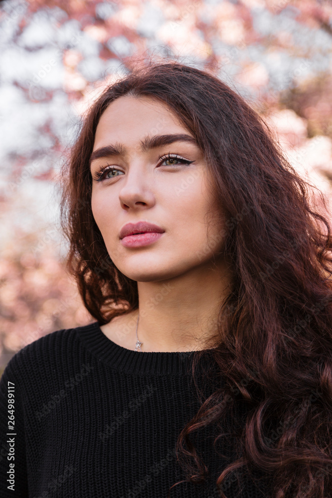 Girl with flowing hair against blooming tree Girl with flowing hair against blooming tree