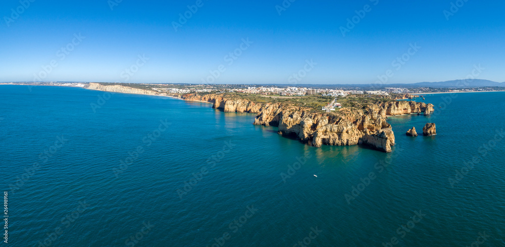 Aerial Scenic seascape, of Ponta da Piedade promontory (cliff formations along coastline of Lagos city), natural landmark destination, Algarve. South Portugal.
