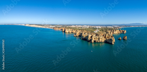 Aerial Scenic seascape, of Ponta da Piedade promontory (cliff formations along coastline of Lagos city), natural landmark destination, Algarve. South Portugal.