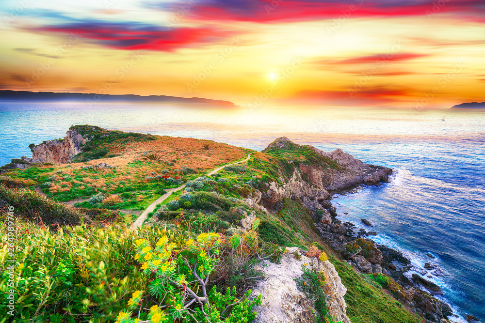 Dramatic spring sunset on the the cape Milazzo panorama of nature reserve Piscina di Venere.