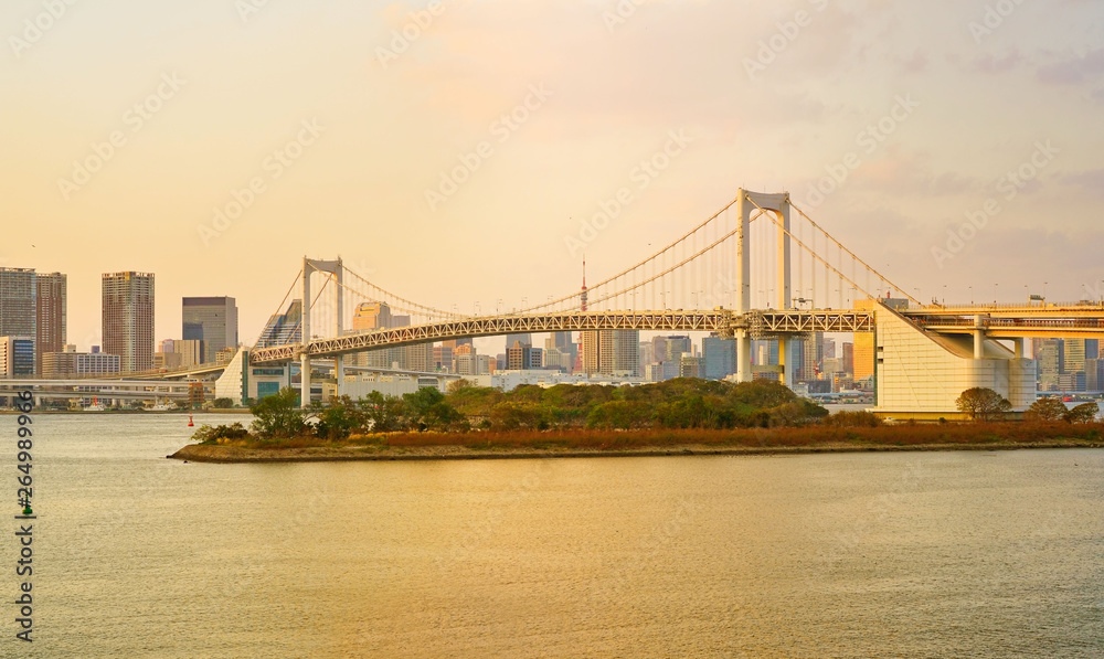 View of the Tokyo Bay and Rainbow Bridge at sunset in Tokyo.