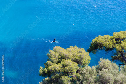 Fototapeta Naklejka Na Ścianę i Meble -  parga sea island blue among green pine trees greece