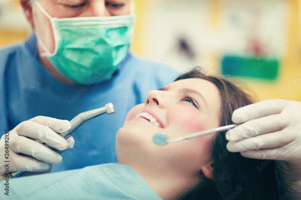 Female patient having a dental treatment Female patient having a dental treatment