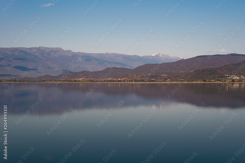 View of the lake and mountains on a sunny spring day.