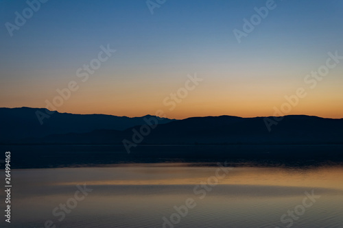 View of the lake and mountains on a sunny spring day.