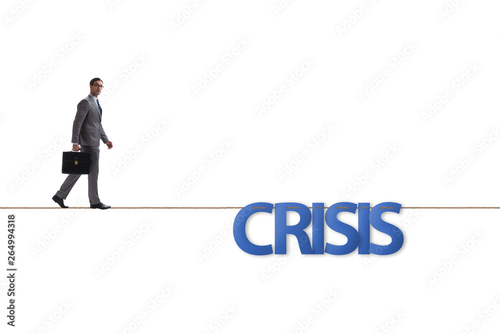 Crisis concept with businessman walking on tight rope Crisis concept with businessman walking on tight rope