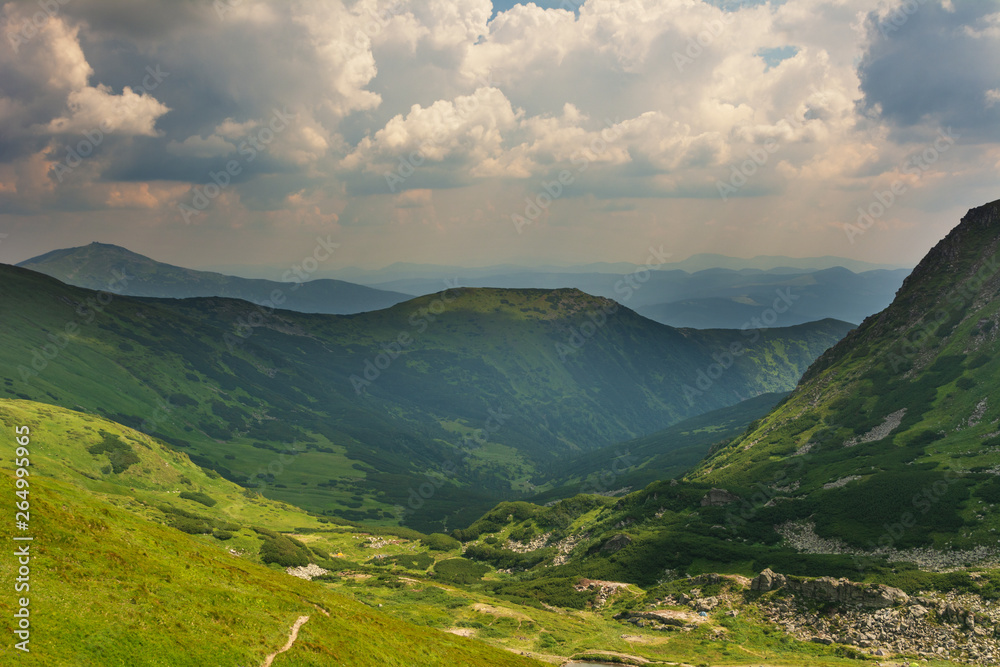 Naklejka premium Warm summer season in the Ukrainian Carpathians with view of the observatory White elephant and tourist with a tent against the background of the mountains