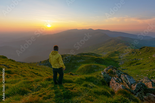 Warm summer season in the Ukrainian Carpathians with view of the observatory White elephant and tourist with a tent against the background of the mountains