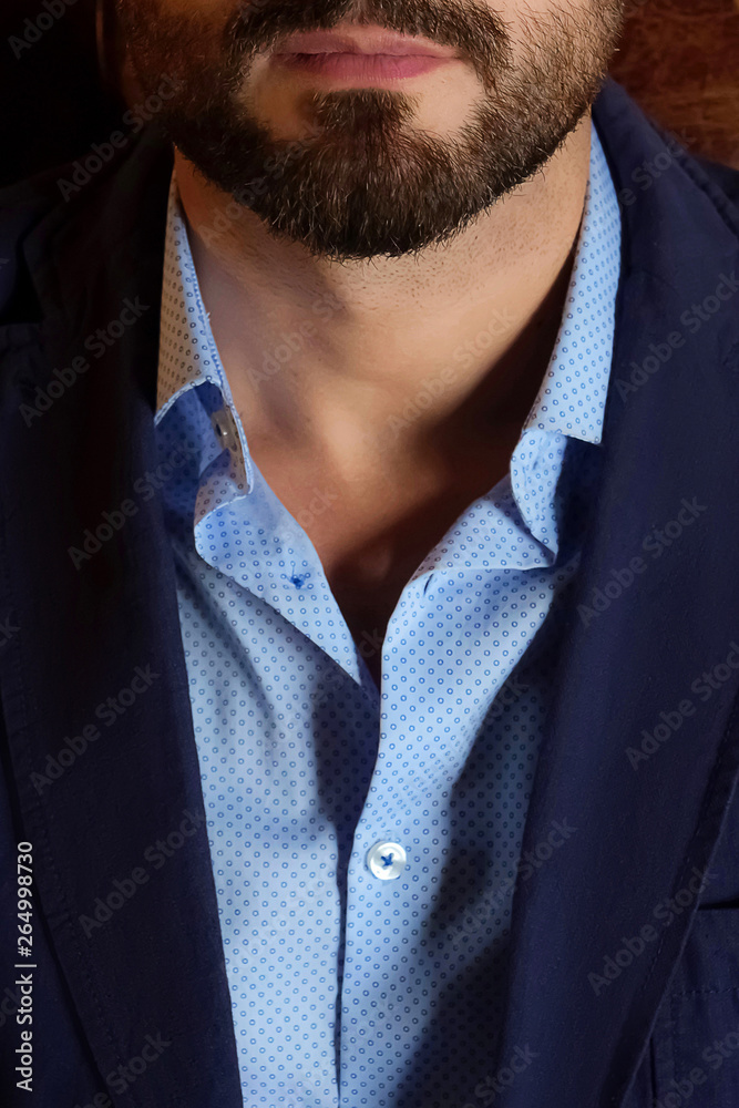handsome bearded man dark blue jacket and shirt, chin close-up