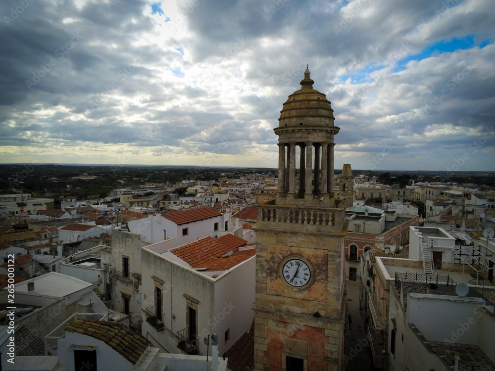 Aerial Shot of the Clocktower that is the Symbol of the City of Noci, Near Bari, in the South of Italy, on Partially Cloudy Sky Background at Sunset
