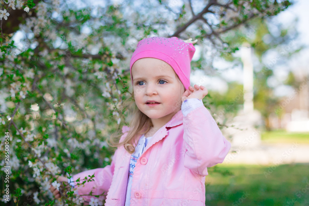 girl, pink hat and jacket, flowering trees, smile girl, pink hat and jacket, flowering trees, smile