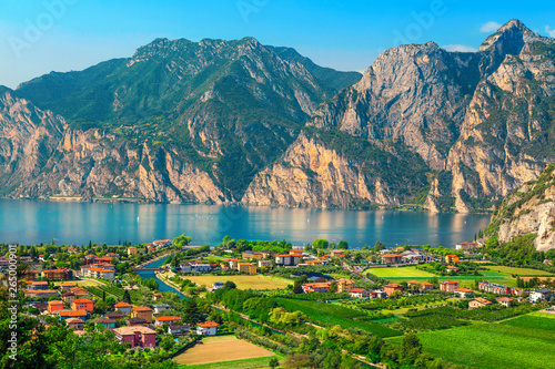 Fototapeta Naklejka Na Ścianę i Meble -  Fantastic Torbole cityscape with plantations and lake Garda, Italy, Europe