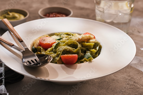 Homemade Tagliatelle pasta with zucchini, tomatoes and cod