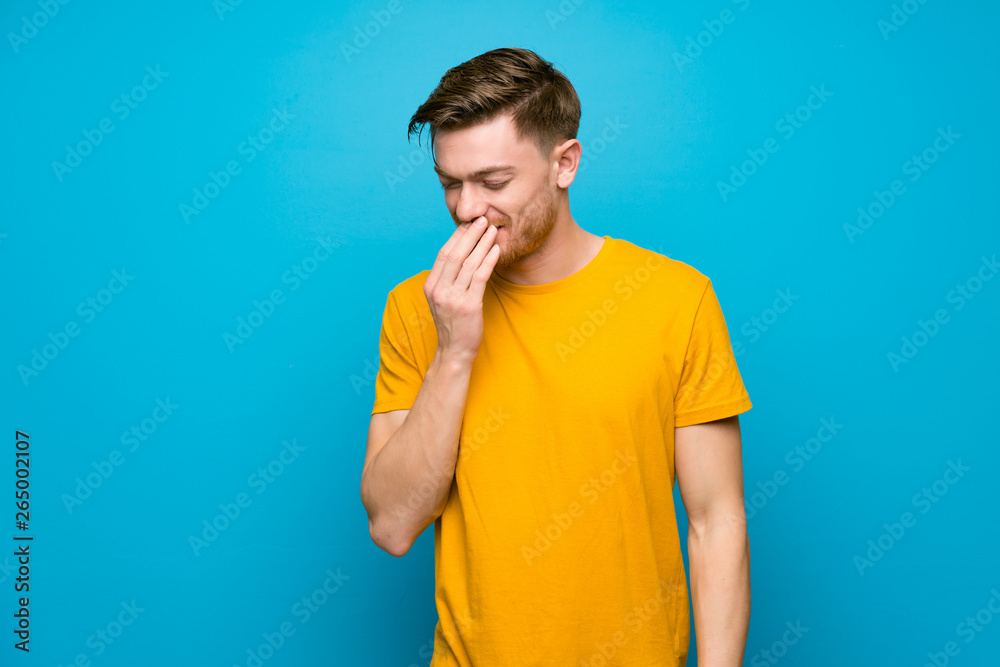 Redhead man over blue wall smiling a lot Redhead man over blue wall smiling a lot