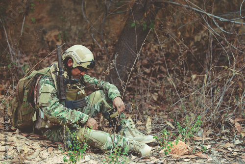 Soldiers of special forces on wars at the desert Thailand people Army soldier Walking patrol Sit for rest from the long Patrol very tired