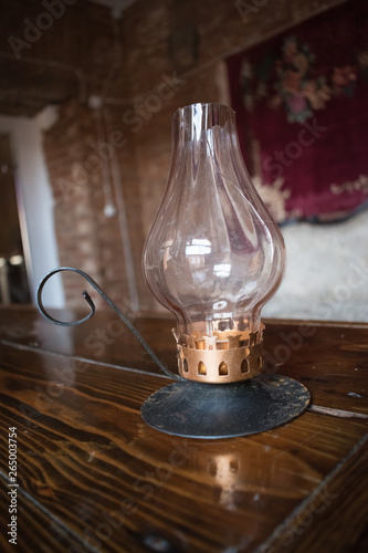 old 19th century kerosene lamps on an old wooden table