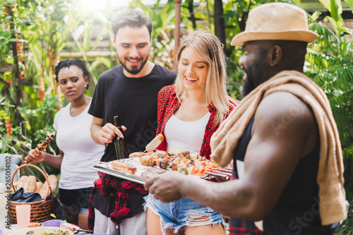 Group of diversity people having barbecue barbeque party at home  cooking grilled meat beef for lunch  happy friends party lifestyle concept