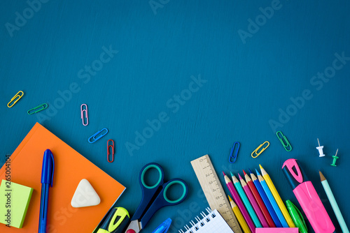 School supplies on blue background. Top view. Copy space. photo