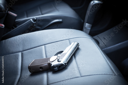 the gun is on the car seat. criminal district of the city photo