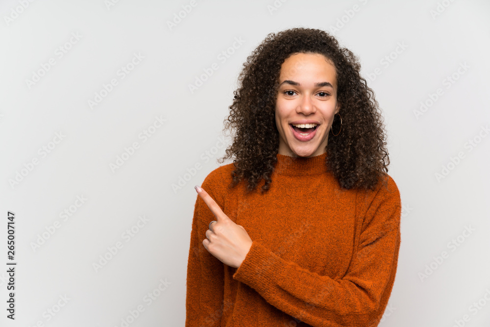 Dominican woman over isolated white wall pointing finger to the side Dominican woman over isolated white wall pointing finger to the side