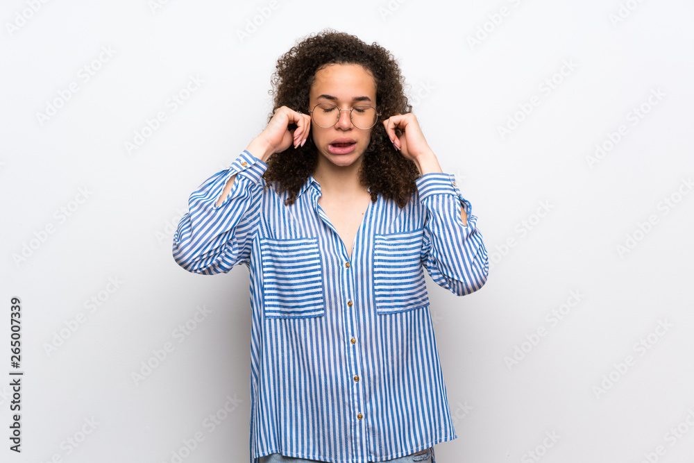 Dominican woman with striped shirt covering ears with hands. Frustrated expression Dominican woman with striped shirt covering ears with hands. Frustrated expression