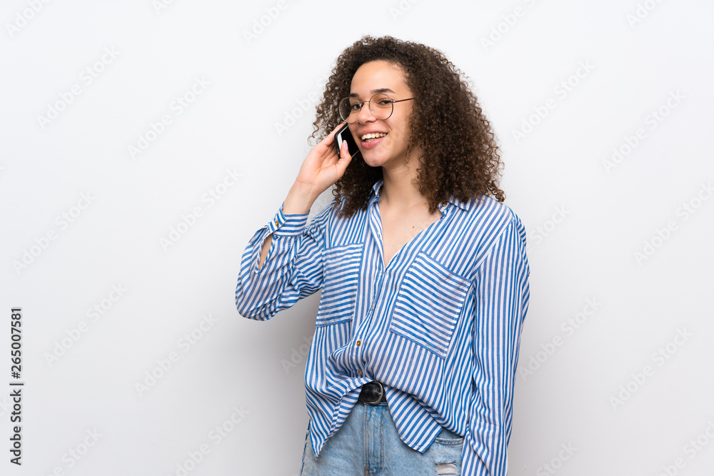 Dominican woman with striped shirt keeping a conversation with the mobile phone Dominican woman with striped shirt keeping a conversation with the mobile phone