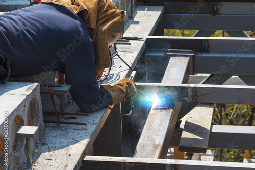 Worker welding in a factory. Welding on an industrial plant.