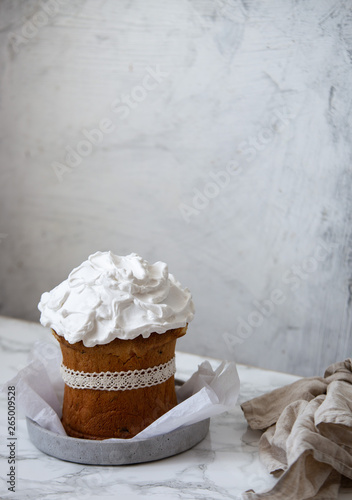Traditional Russian Orthodox Easter bread - kulich in rustic plate on marble background with copy space