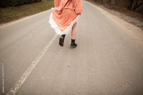 Close up on woman's legs on the road. Woman running