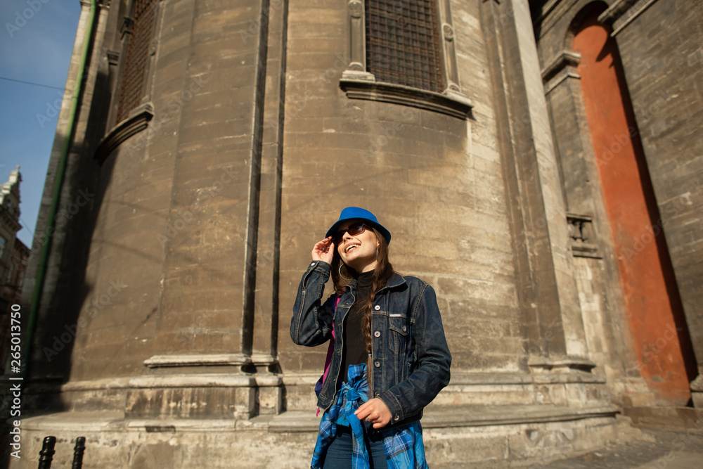 Young woman standing near the church in old city Lviv. Ukraine