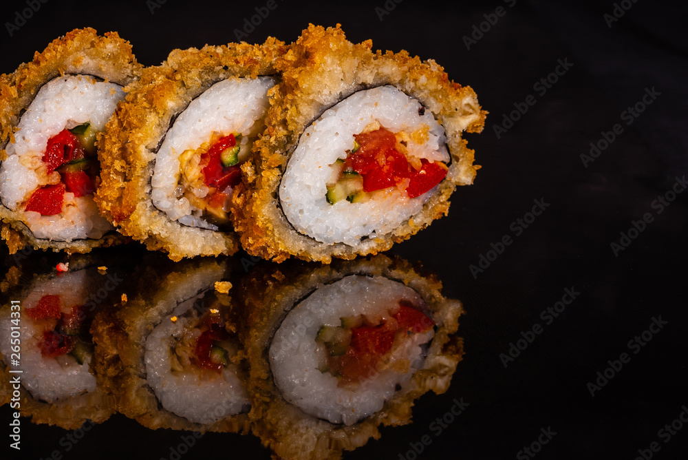 Fresh and tasty sushi on dark background. It can be used as a background Fresh and tasty sushi on dark background. It can be used as a background