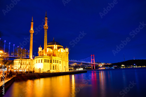 View of the Ortakoy Mosque in Istanbul City of Turkey. Historical Tower and sunset at Bosphorus.