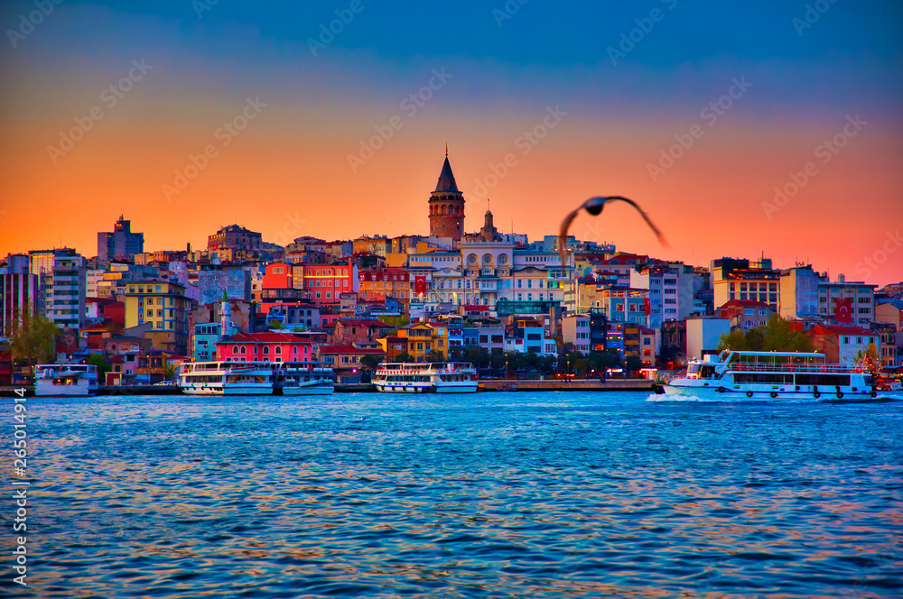 View of the Istanbul City of Turkey. Historical Galata Tower and sunset at Bosphorus.