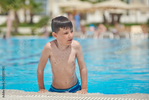 Portrait of Caucasian boy spending time in pool at resort.